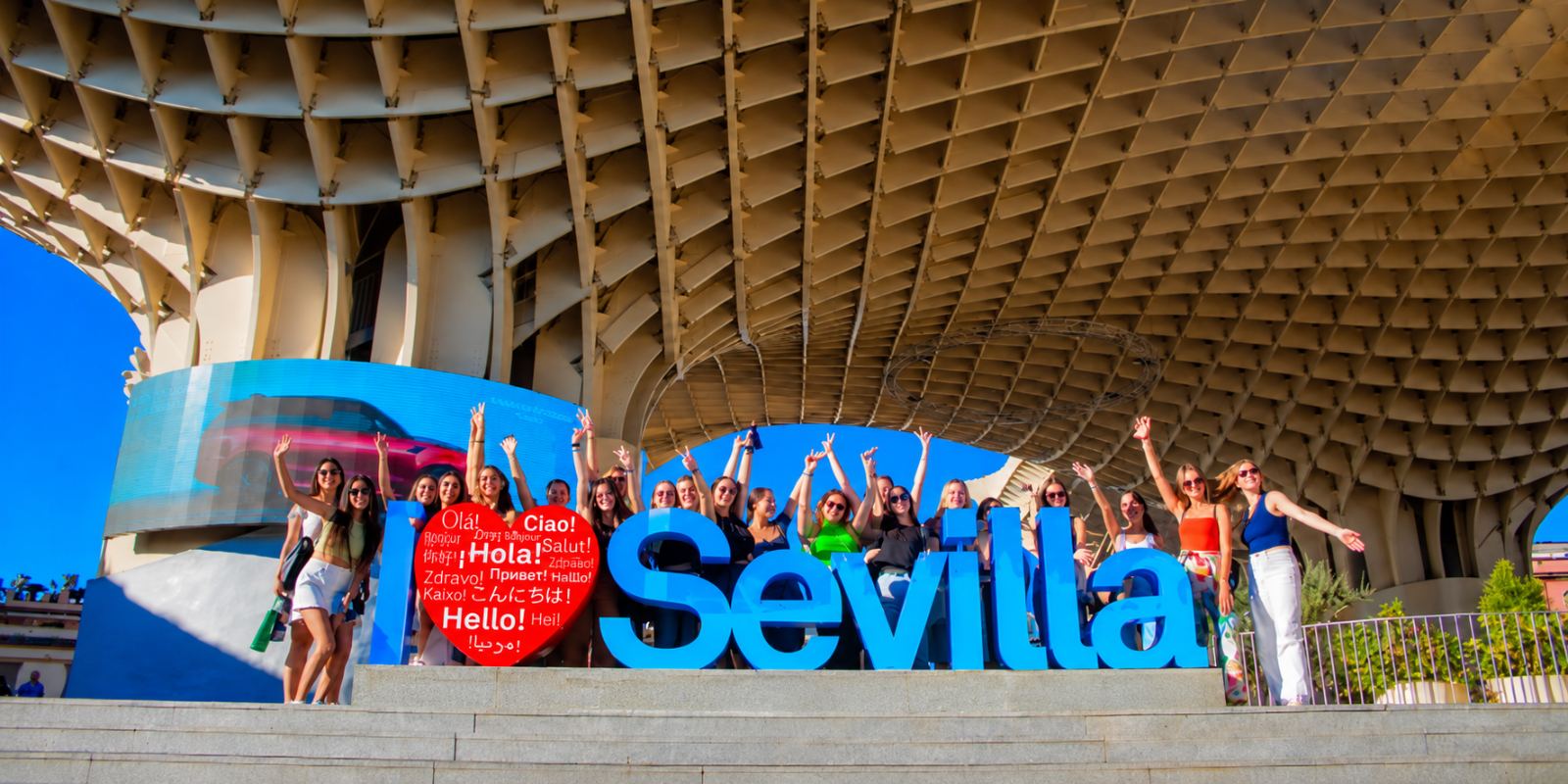 Grupo de turistas junto al cartel de Sevilla bajo las Setas